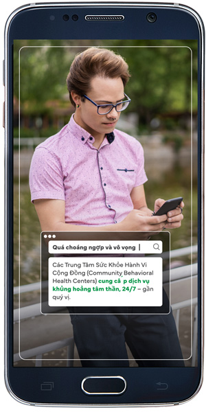 NearMe-Mockup Sample social ad from campaign – Vietnamese man looking at phone looking for Mental Health Services near him